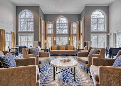 A large room with a lot of chairs and a table in the middle.