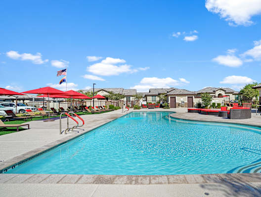 A large swimming pool with a red pool ladder.