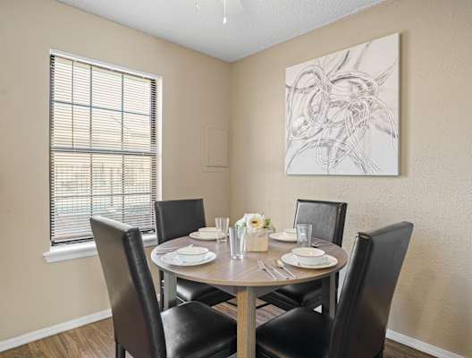 dining room area with brown table and brown chairs and large window
