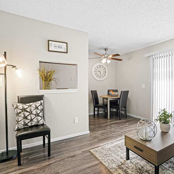an open living room and dining room with a ceiling fan at Diamond Creek Apartments, Norman, 73072