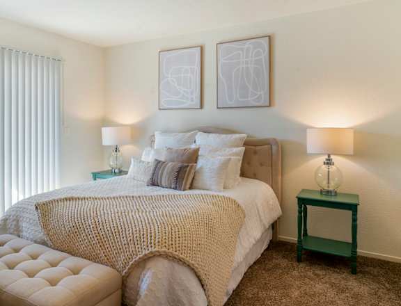 a bedroom with a bed and two night stands