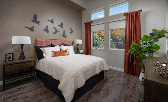 a bedroom with a bed and birds on the wall