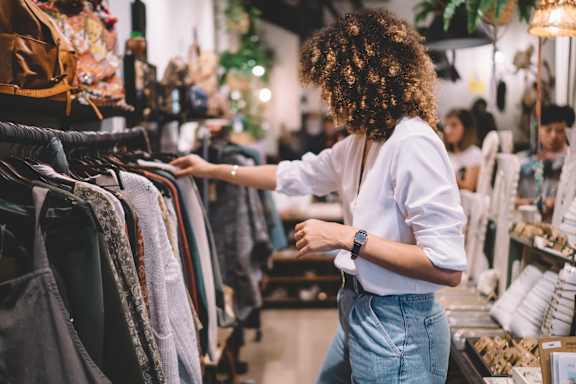 A woman is shopping for clothes in a store.