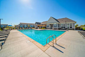 A large swimming pool with a sunny sky above.