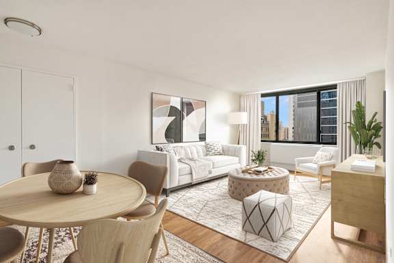 A modern living room with a large window, a white sofa, and a wooden coffee table.at Carnegie Mews, New York, NY 10019