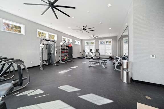 A spacious gym with a variety of equipment including treadmills, weights, and exercise machines.