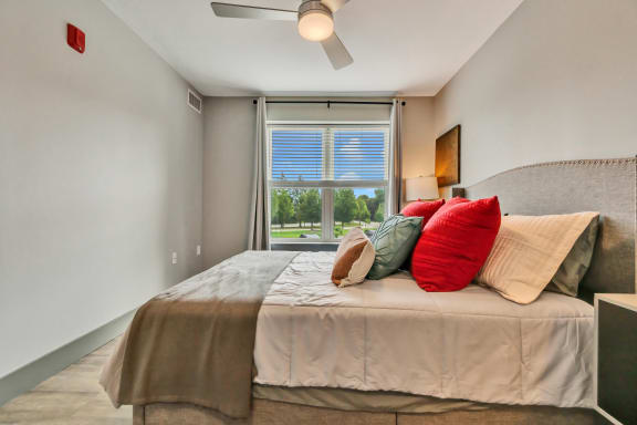 a bedroom with a large bed and a ceiling fan
