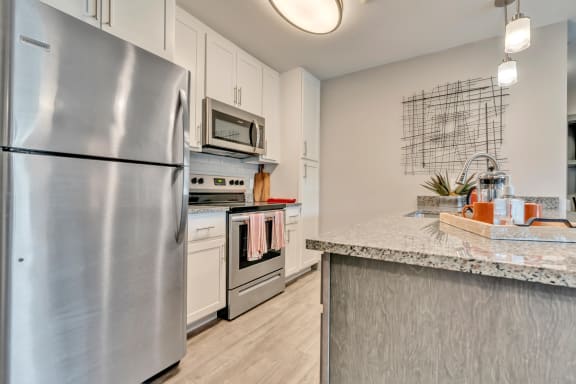 kitchen with stainless steel appliances at the bradley braddock road station apartments