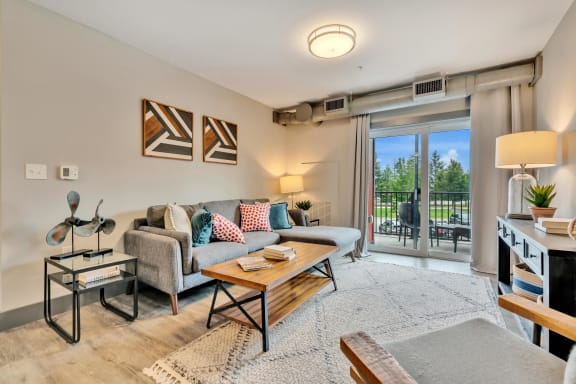 the living room has a large sliding glass door that leads to the balcony