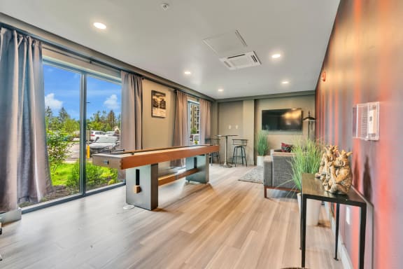 a room with a pool table and a large window