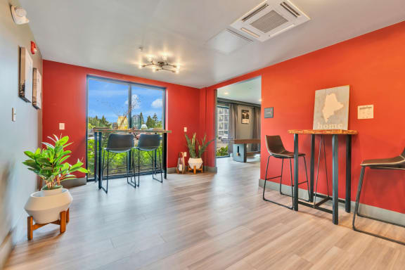 a room with a bar and a large window with a view of the city