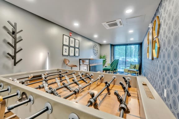 our exercise room has a foosball table and a ping pong table