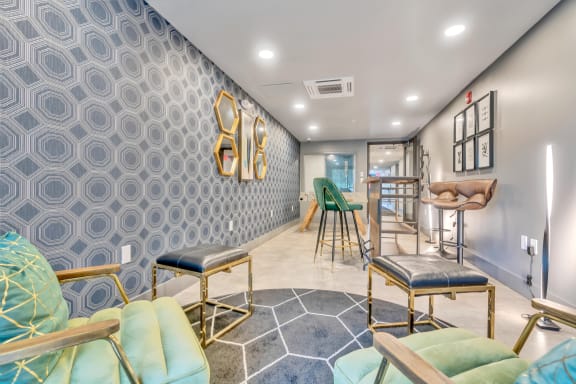 a seating area with stools and a table with chairs