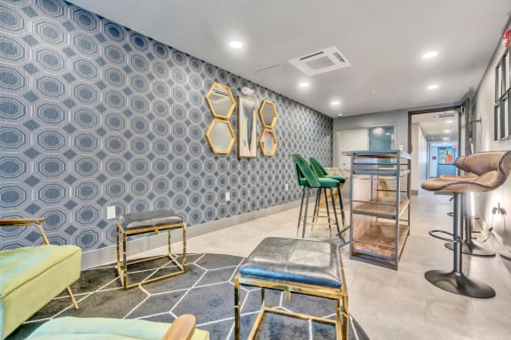 a seating area with stools and tables