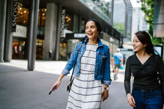 two women walking down the street