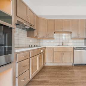 a kitchen with wooden cabinets and stainless steel appliances