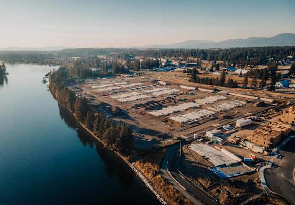 an aerial view of a construction site next to a body of water