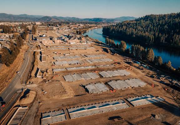 an aerial view of a construction site next to a river