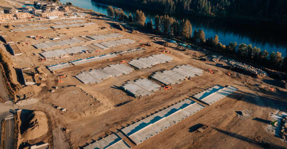 an aerial view of a construction site next to a river