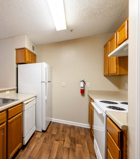 an empty living room with a table and chairs at Lakeside Gardens Apartments, Durham, NC