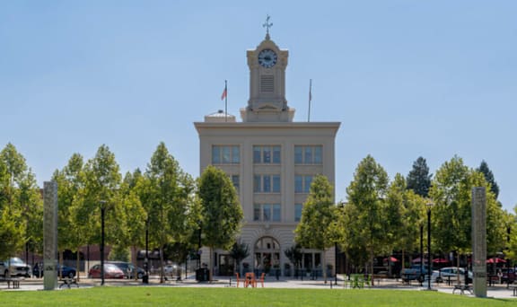 Exterior View of Large White Building and Lush Landscaping
