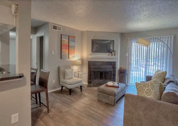 a living room with a couch and chairs and a fireplace at The Manhattan Apartments, Dallas, TX, 75252