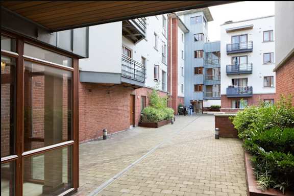 the view of an empty courtyard from an apartment building