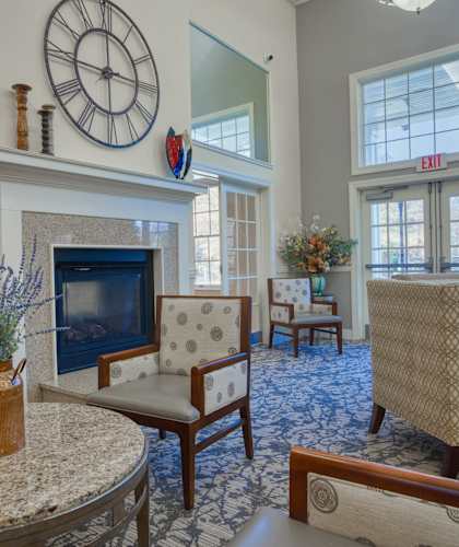 a living room with a fireplace and a clock on the wall
