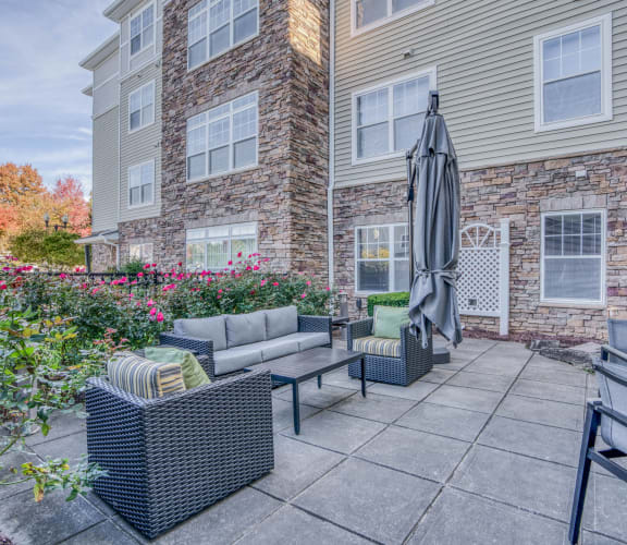 our apartments offer a patio with furniture and an umbrella