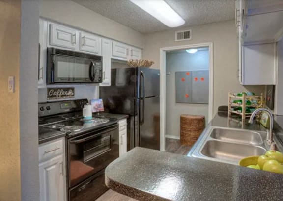 a home office with a desk and a computer at The Manhattan Apartments, Dallas, TX, 75252