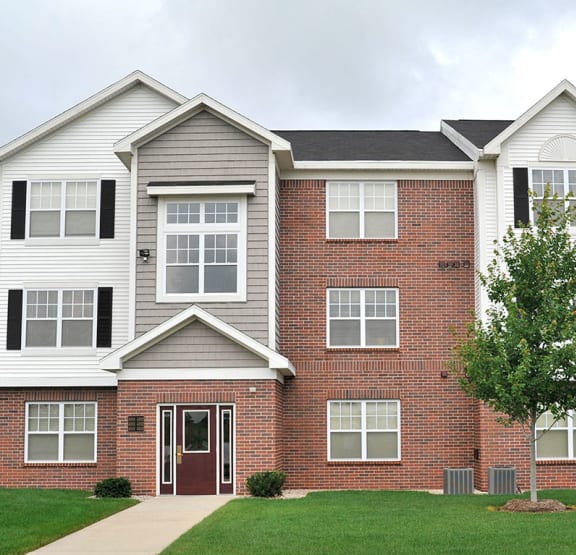 a living room with a couch and a television at Towne Lakes Apartments in Grand Chute, WI, 54913