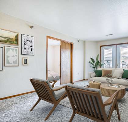 a living room with a couch and a table and chairs