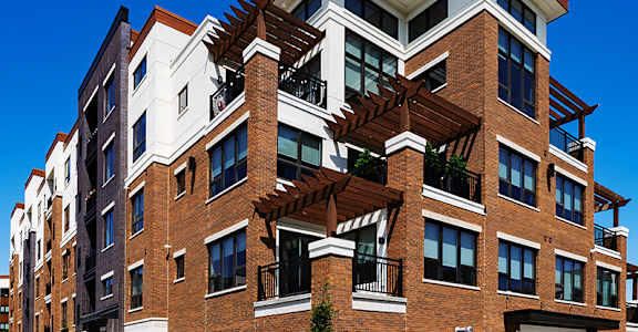 A modern multi-story building with a mix of brick and white exterior walls.