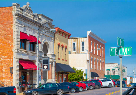 a city street with cars parked in front of buildings
