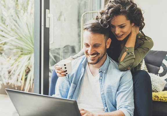 Couple looking at a laptop at Whispering Hills, Omaha, Nebraska