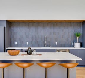 a kitchen with a white counter top and a sink