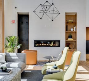 a living room with a couch and chairs and a fireplace
