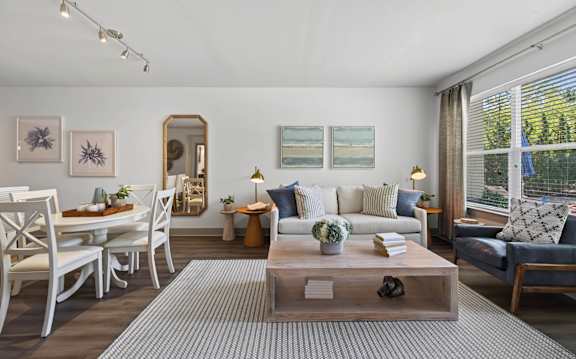 A living room with a grey sofa, a wooden coffee table, and a television.