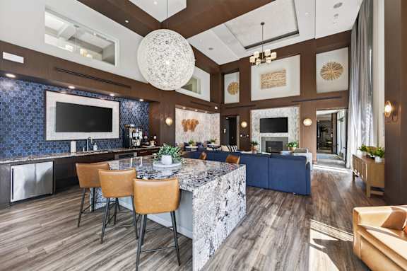 A modern kitchen with a bar area and a dining table.