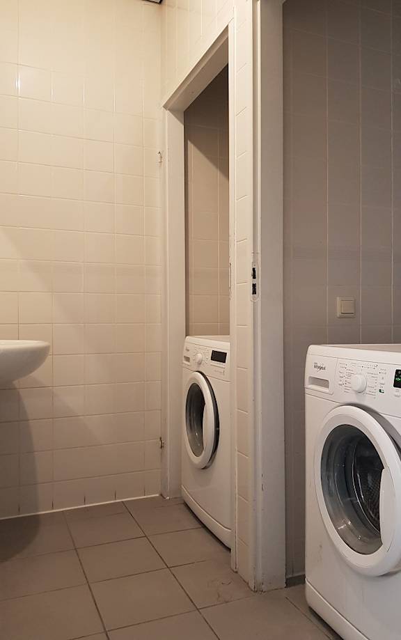 a white bathroom with a sink and a toilet