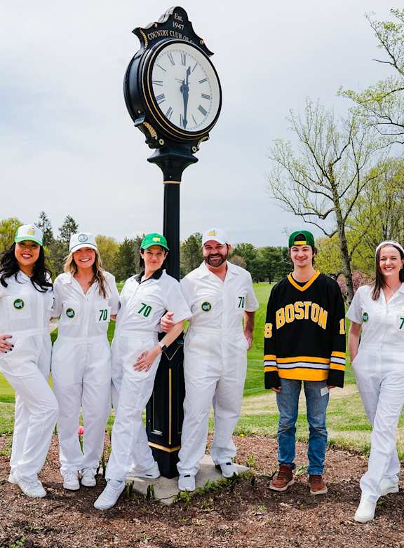 A group of people in white uniforms posing in front of a clock. at Northlake Park Apartments, Orlando, FL, 32827
