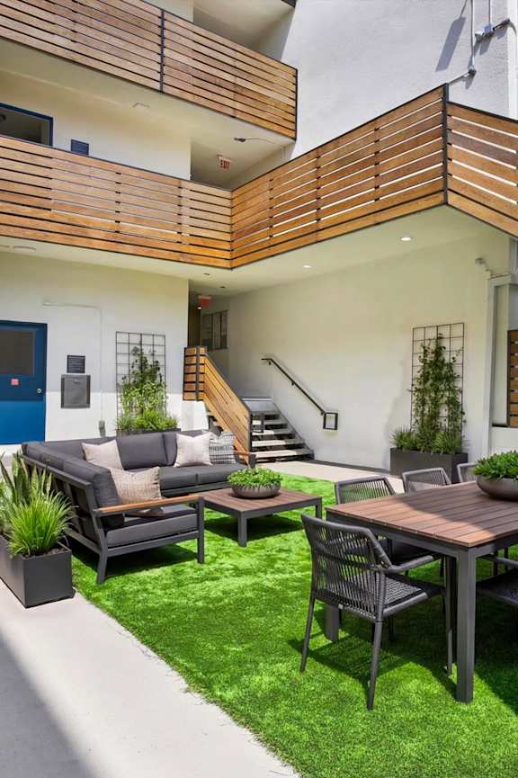 A modern patio with a table and chairs.