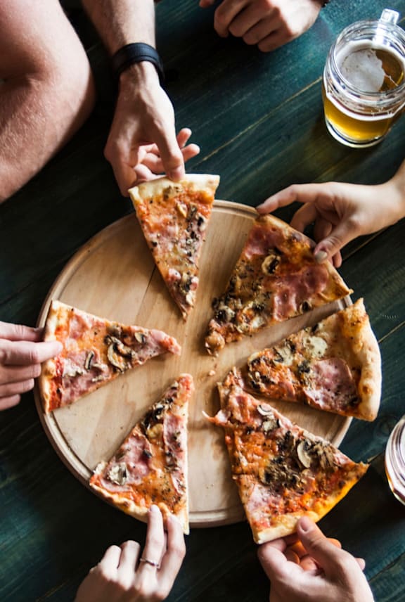 Group of People Sharing Pizza