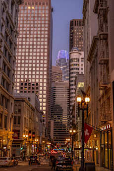 A city street with cars and buildings.