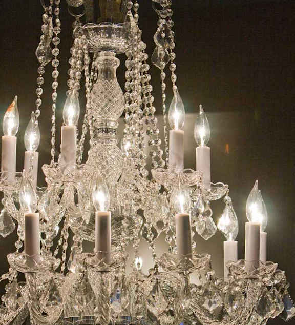 A chandelier with multiple candle-like lights is hanging from the ceiling.