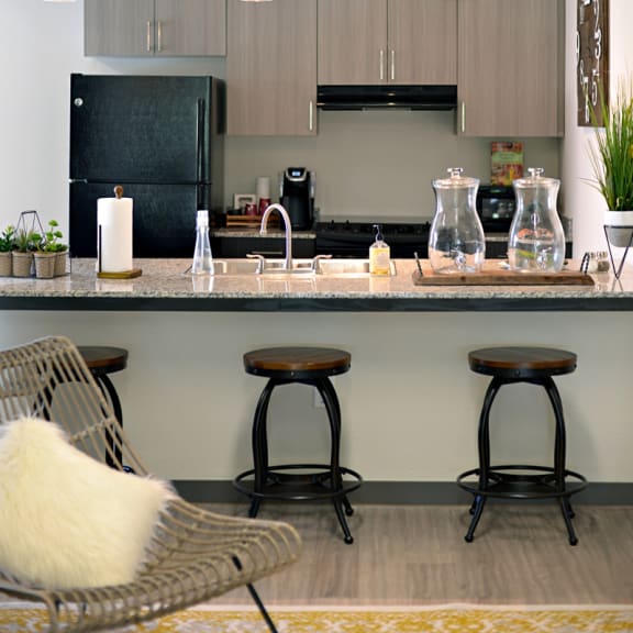 a kitchen with a bar and stools at The Liberty Lofts, Gainesville, 76240