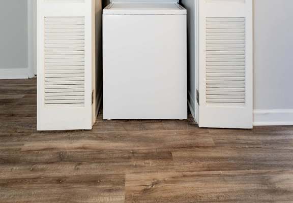 A white washing machine is built into a wall.at McDonogh Village Apartments & Townhomes, Randallstown, MD, 21133