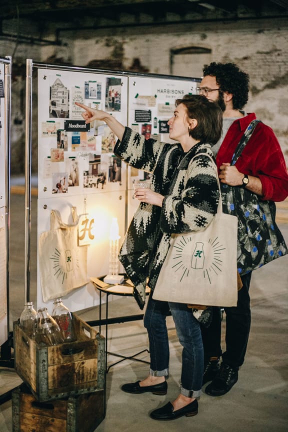 a couple of people standing in front of a poster
