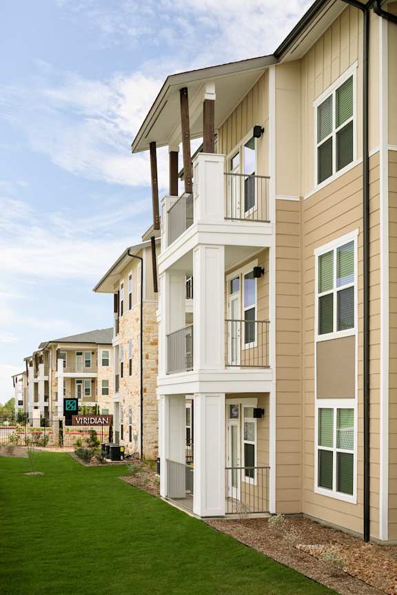 Modern apartment homes with private balconies, attractive exterior finishes, and beautifully maintained landscaping.