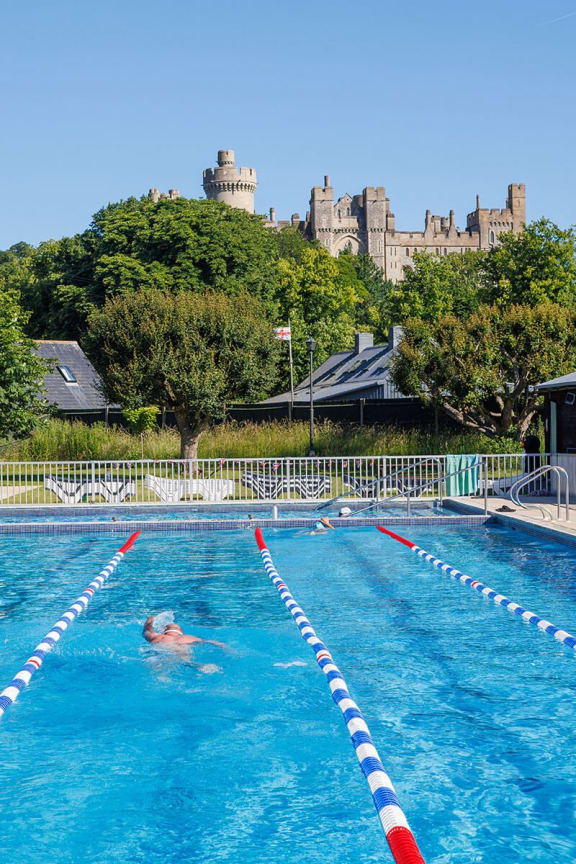 a swimming pool with a castle in the background